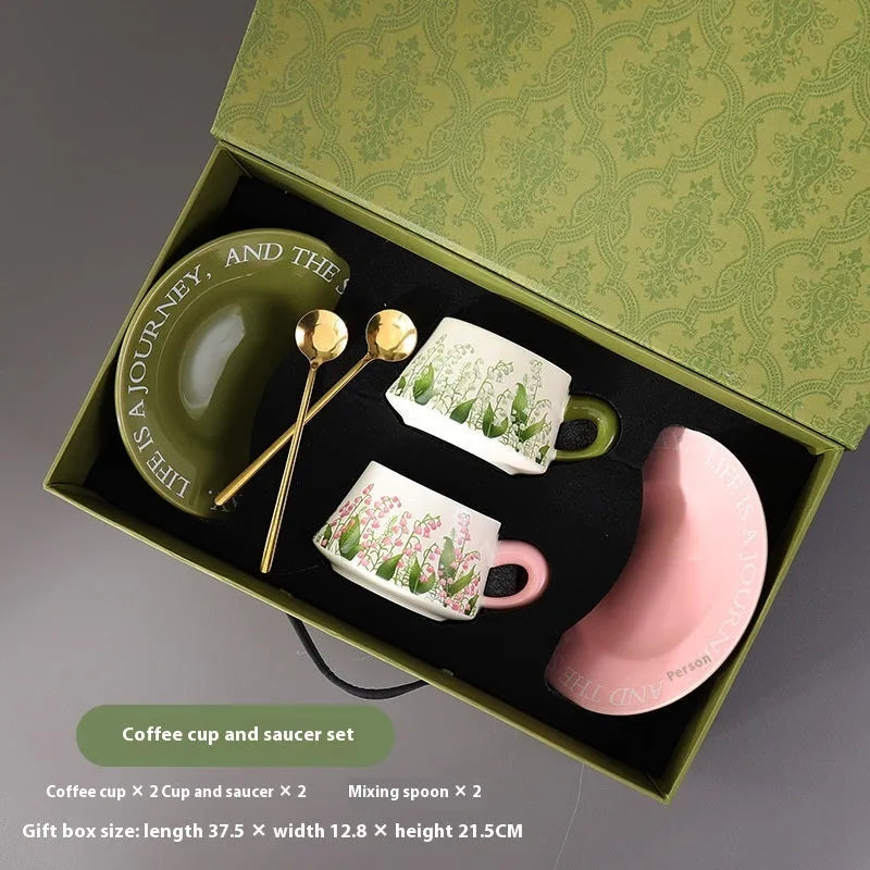 Ceramic coffee cup and saucer set for two people with stirring spoons