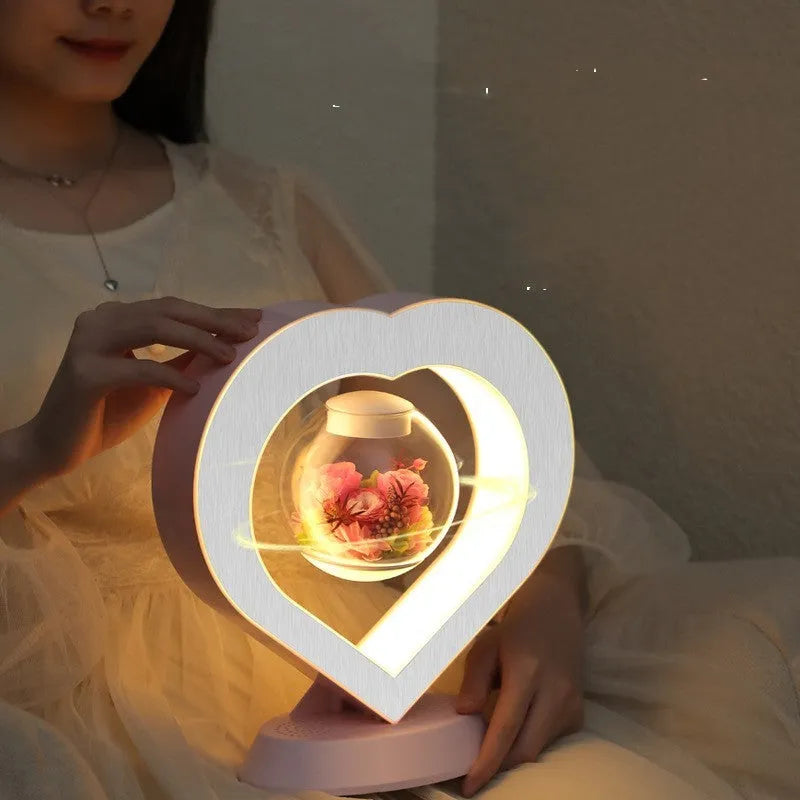 Magnetic levitation lamp with pink eternal rose inside transparent sphere and Bluetooth speaker on USB base