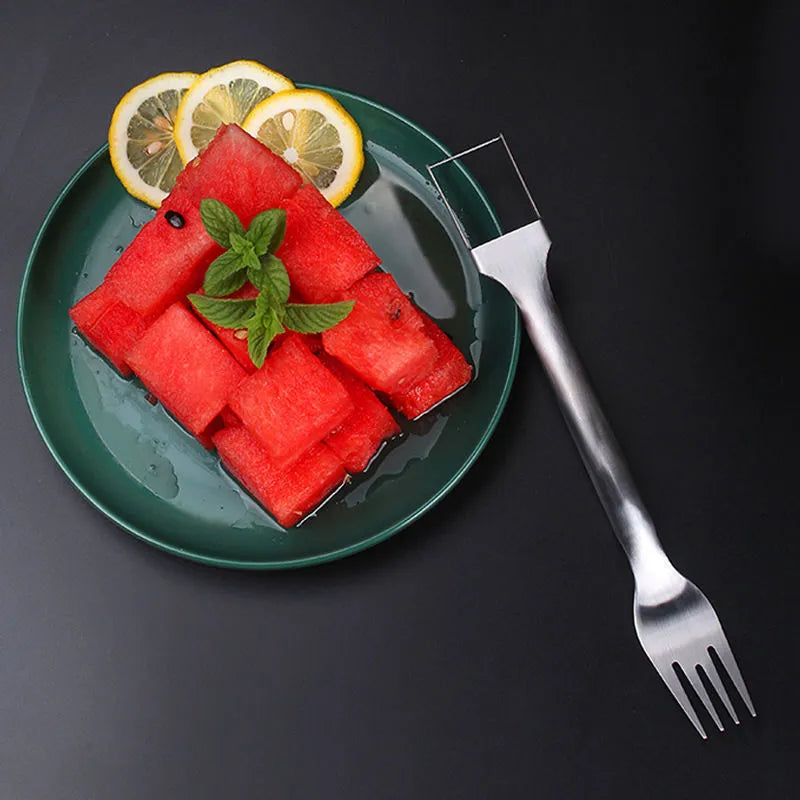 Stainless steel watermelon slicer and fork tool on a kitchen surface