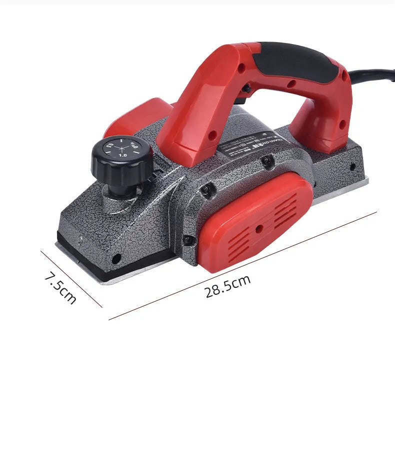 Red aluminium electric wood planer with 82mm width on workbench