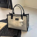 Women's black canvas tote bag with rhombus pattern and sandwich pocket compartments