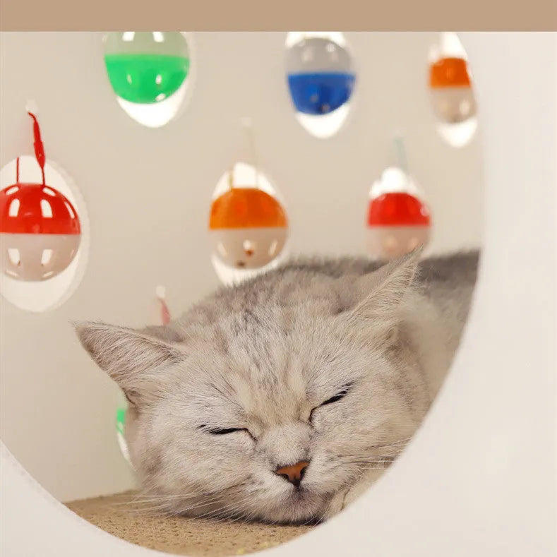 Plastic integrated cat scratch board, nest bed, and tunnel toy with a bell.