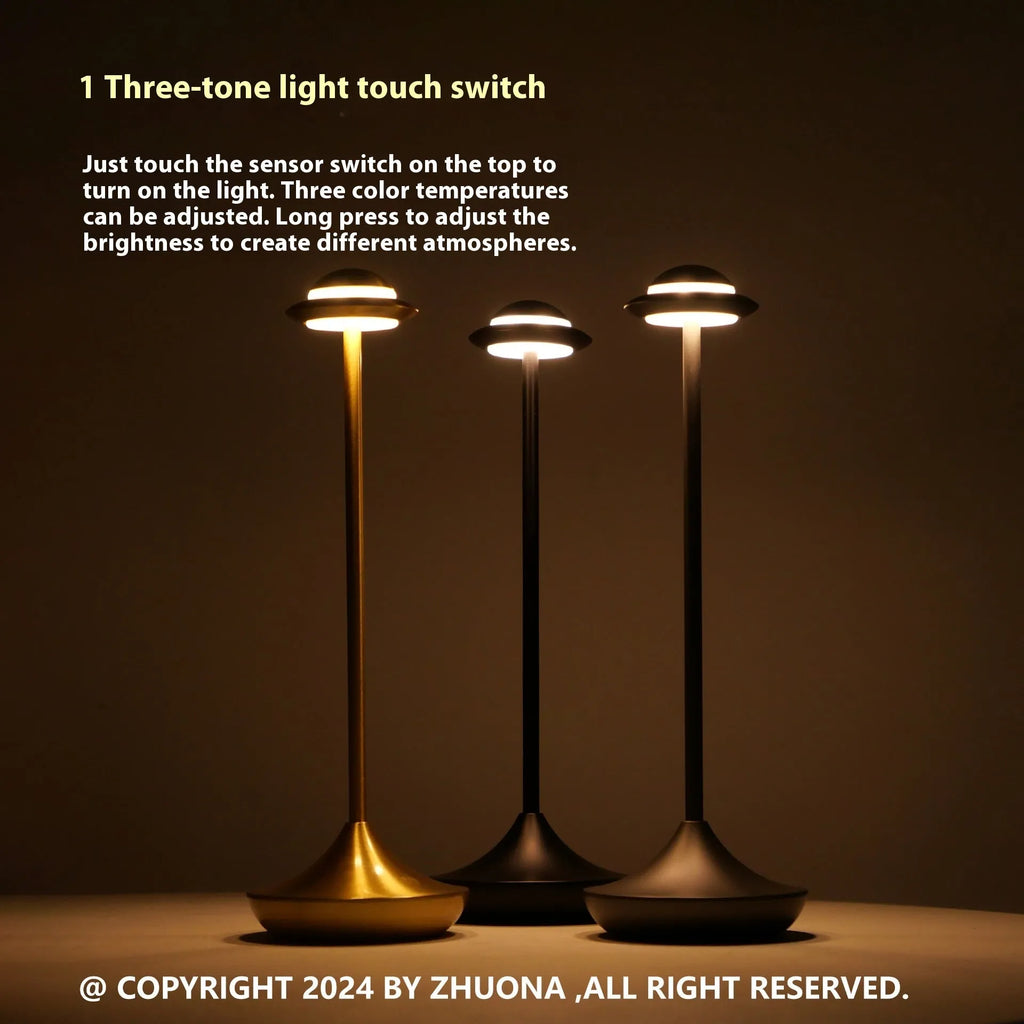 Creative metal UFO-shaped rechargeable desk lamp with touch dimming in gold, grey, and black colours.