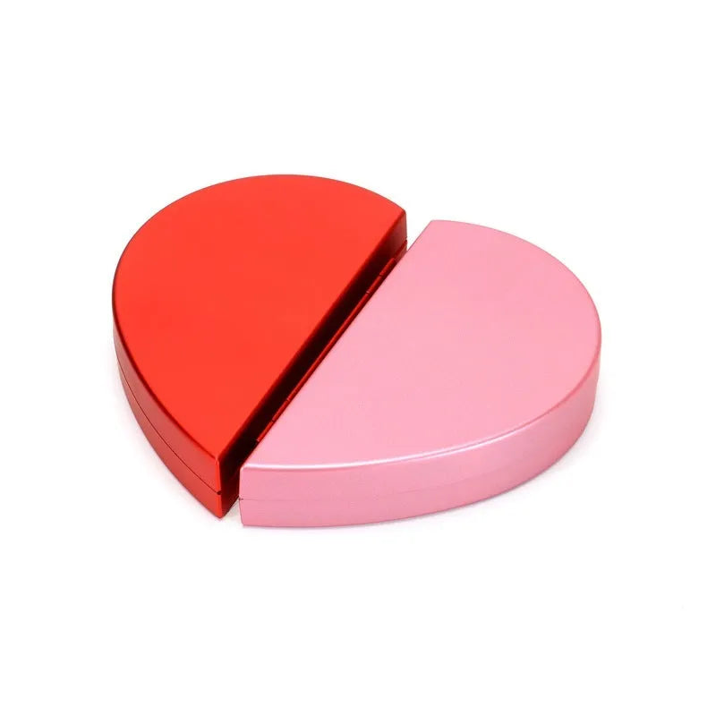Red plastic heart-shaped rotating ring box with rose decoration inside white storage case