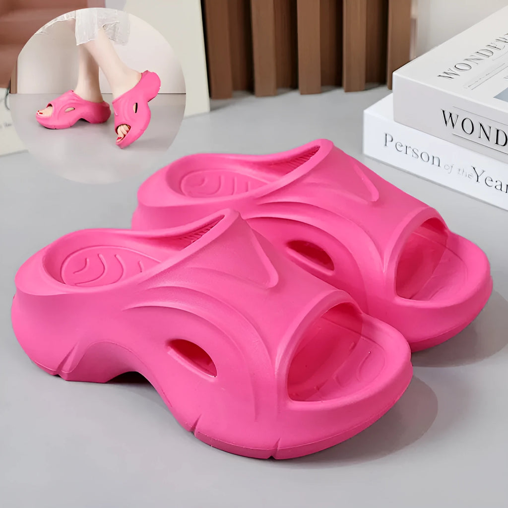 Women's white thick-soled EVA slippers with round toe on a beach background.