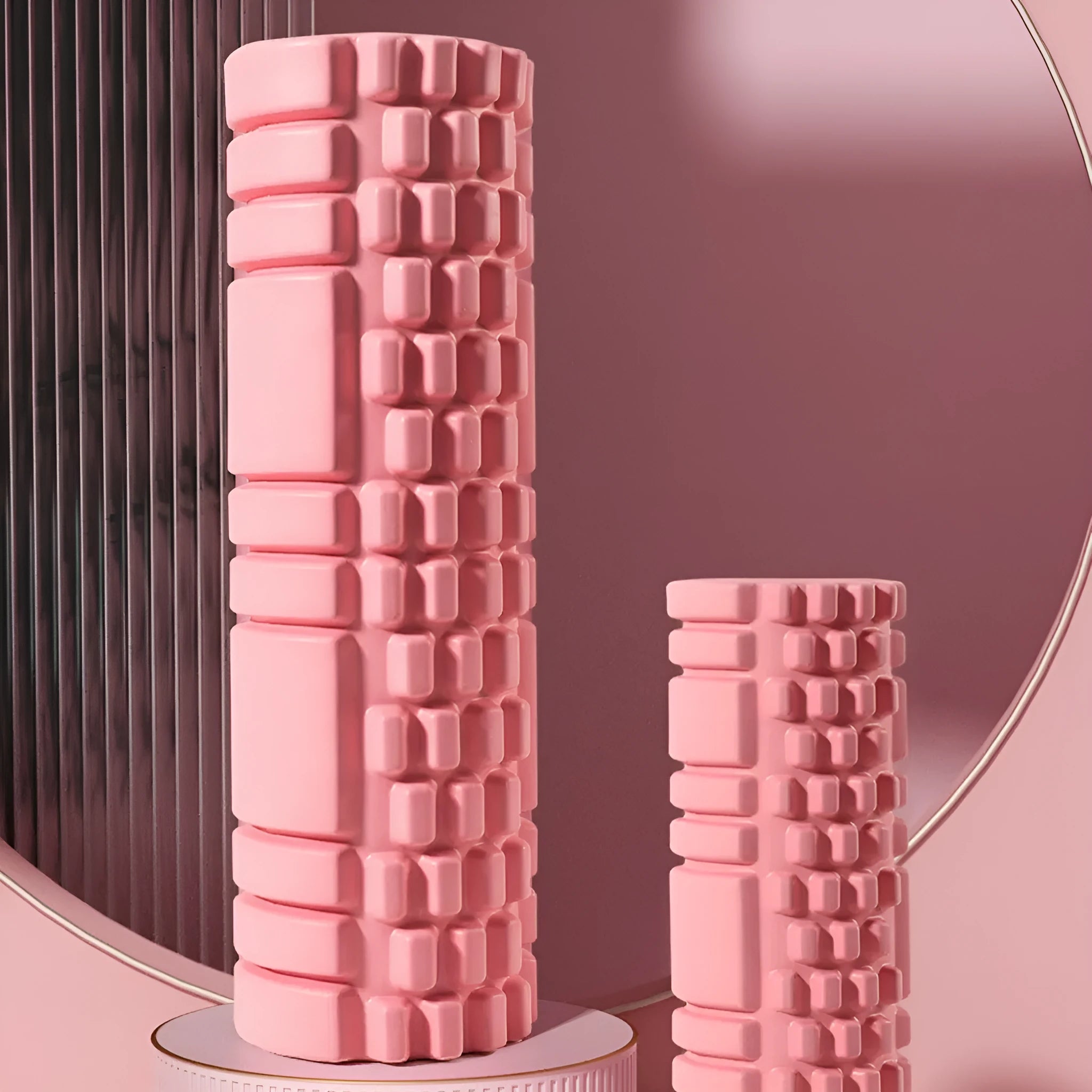 A firm EVA foam roller for fitness and muscle recovery, shown in a selection of colours including pink, blue, and grey.