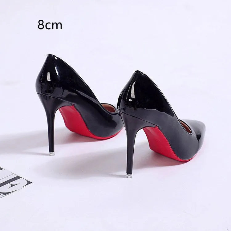 Women's black stiletto heel pump with pointed toe and shallow cut on a white background.