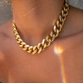 Gold-coloured women's thick chain alloy necklace with a pendant, showing its 32cm length.