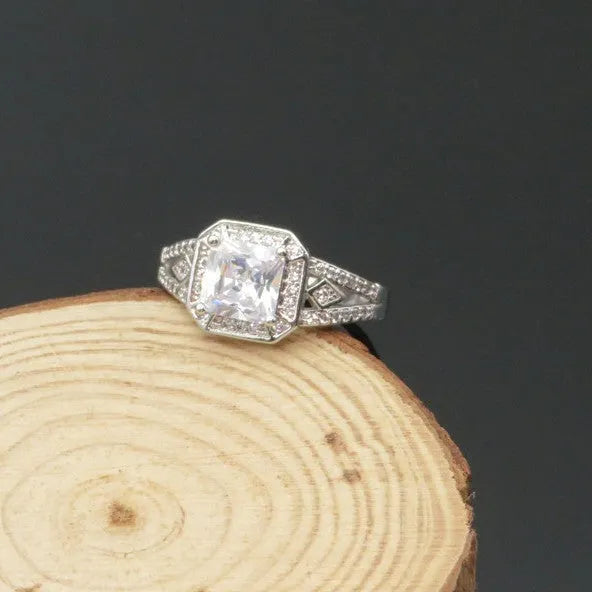 Geometric hollow design women's zircon ring in platinum finish on copper, showing quadrilateral stone.