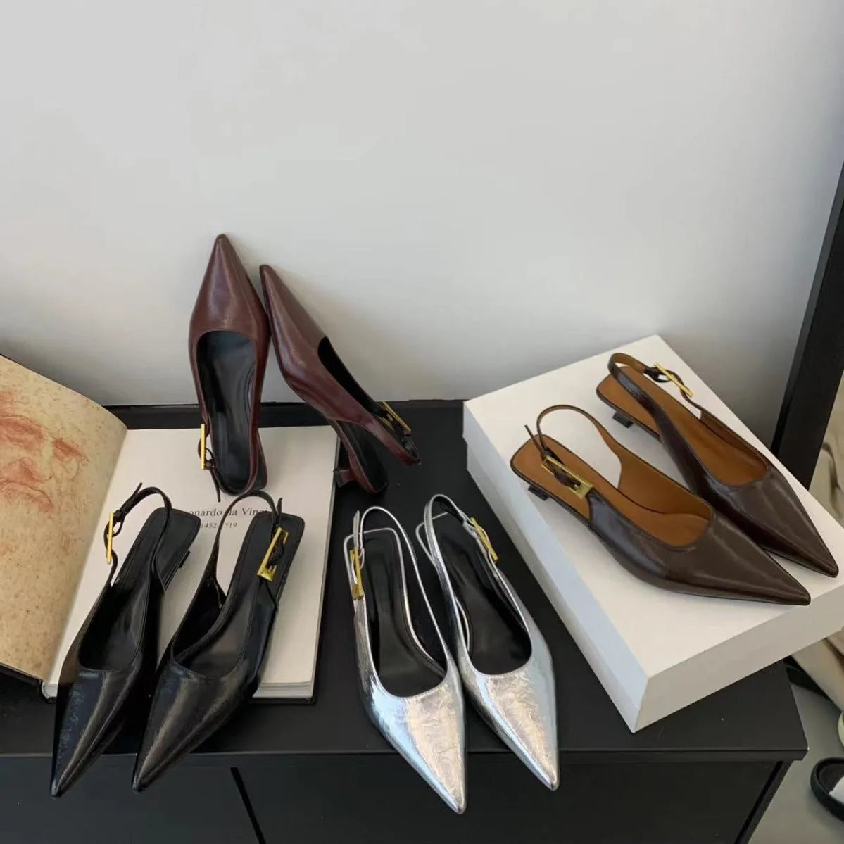 Women's black leather low heel strap shoes with pointed toe and thin rubber soles