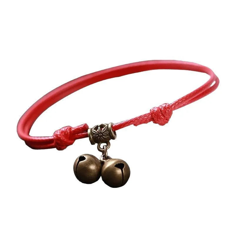 Black nylon rope dog collar with a small brass bell, shown adjusted on a model.