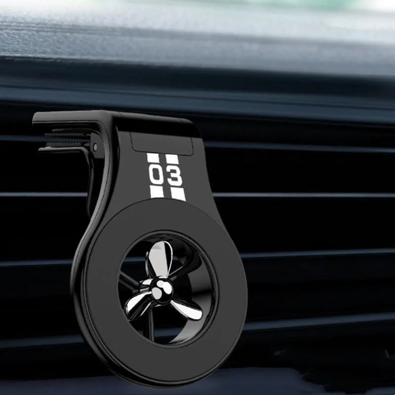 Magnetic car air vent phone holder with perfume diffuser in black, showing 360-degree rotation