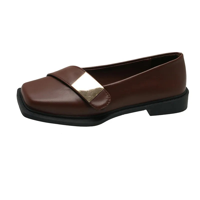 Women's beige square-toe flat shoes with a metal buckle and low rubber sole.