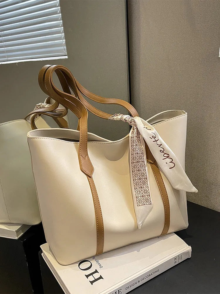 Soft large tote shoulder bag with crossbody strap in multiple colour options including black, khaki, and white with coloured trim