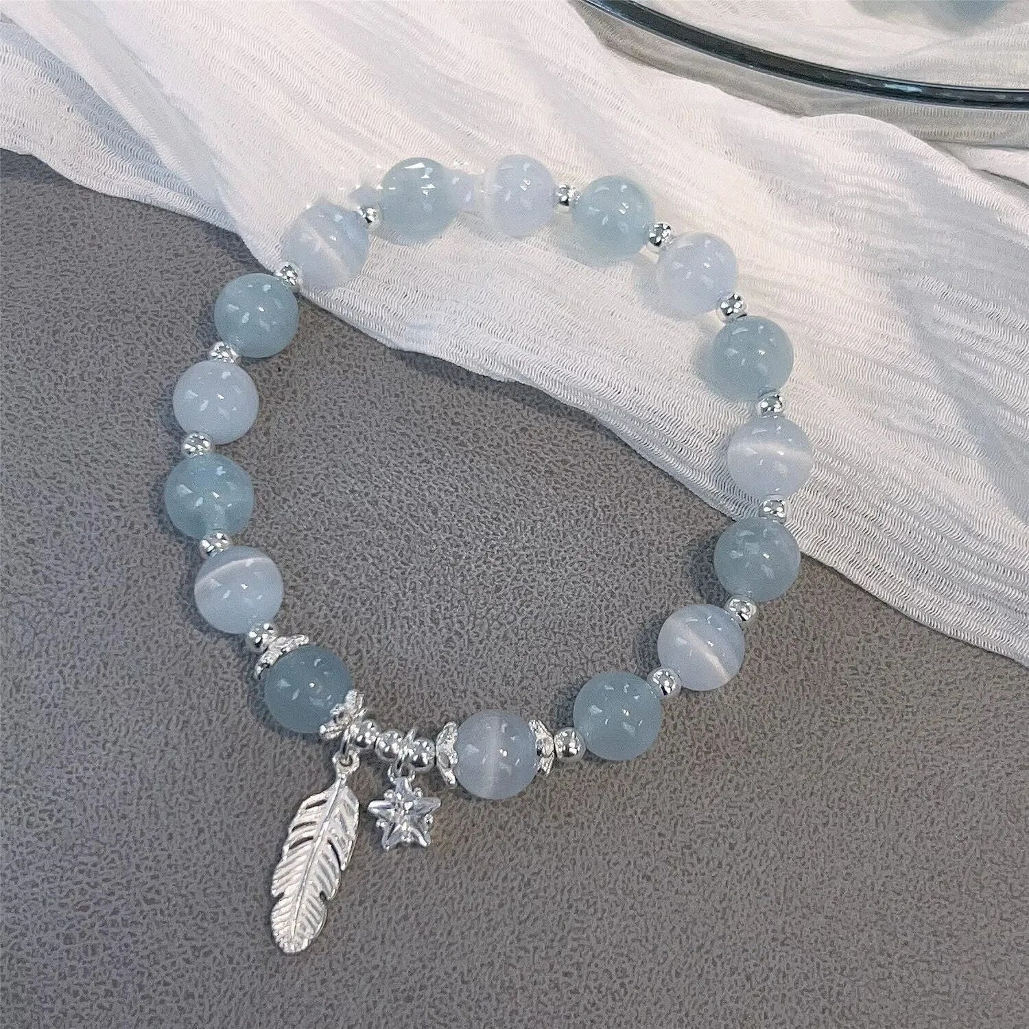Glass crystal bead bracelet with blue moonlight colour and eight star design elements