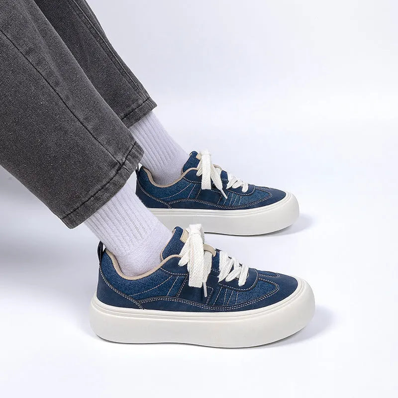 Men's low-top black canvas platform shoes with white raised sole and front lace-up.