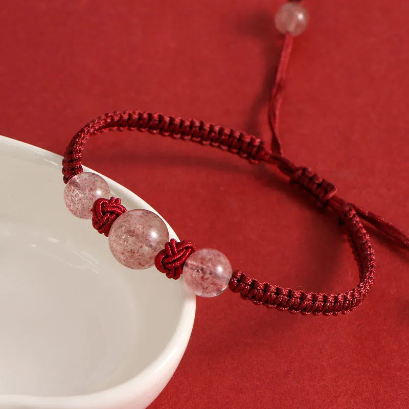 Woven rope bracelet with spherical strawberry quartz beads and alloy accents