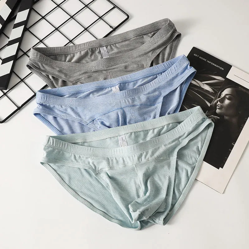 Women's low-waist modal briefs in jacquard knit, showing colour options: dark grey, green, sky blue, pink, and colourful blue.
