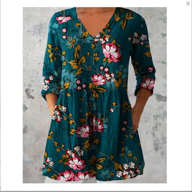 Women's loose-fit dress with blue and white wave pattern print and three-quarter length sleeves.
