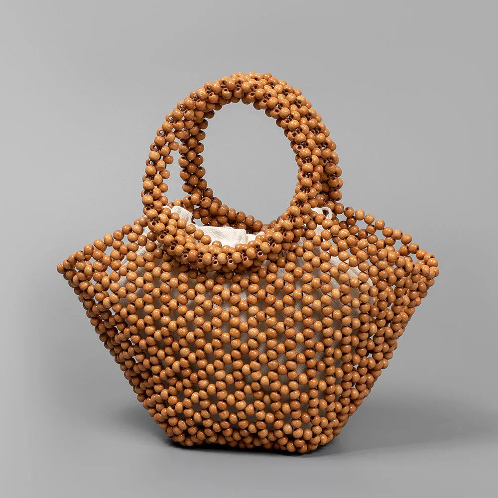 Hand-woven maple wooden bead beach bag in dumpling shape with hollow weave design