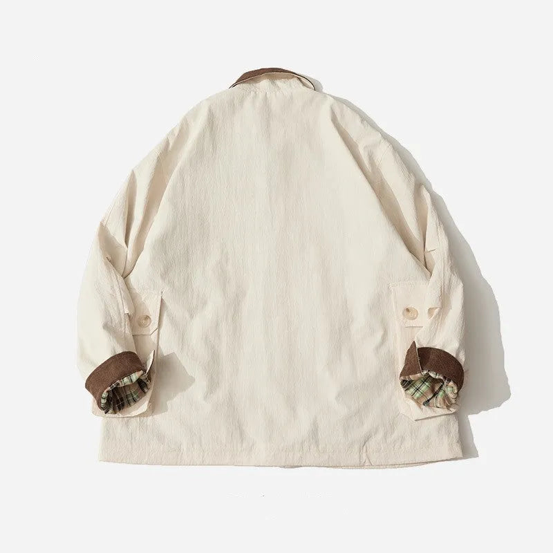 Green and apricot contrast colour casual jacket with side seam pockets on a hanger