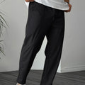 Man wearing khaki straight-leg drawstring trousers with a tonal ribbon pocket detail.