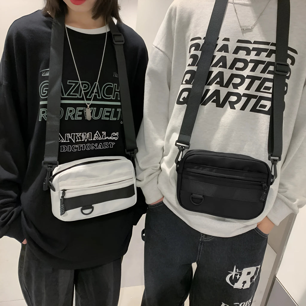 Men's street-style nylon messenger crossbody bag in black, shown with sewing thread detail.