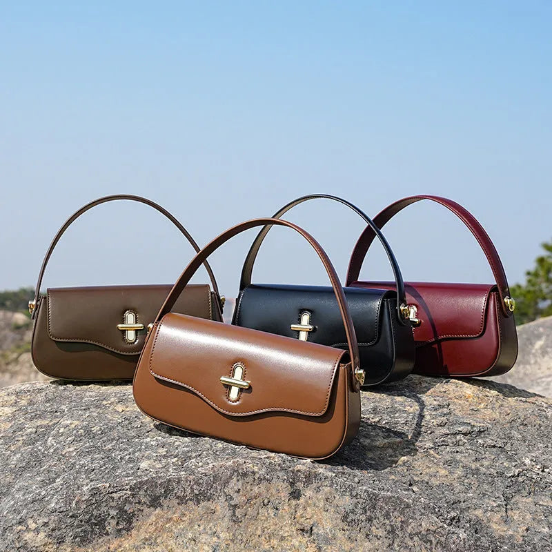 Genuine leather baguette handbag in horizontal square clamshell design, shown in black colour