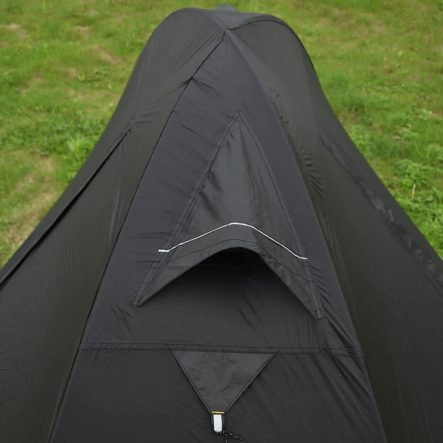 Black single person double account tent with aluminium poles pitched outdoors.