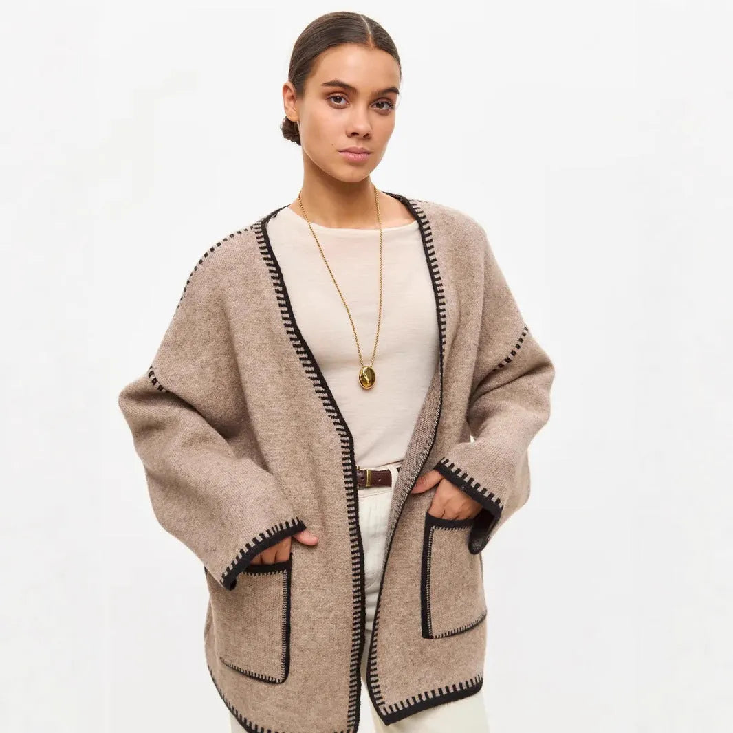 Loose mid-length knitted cardigan in camel colour on a hanger