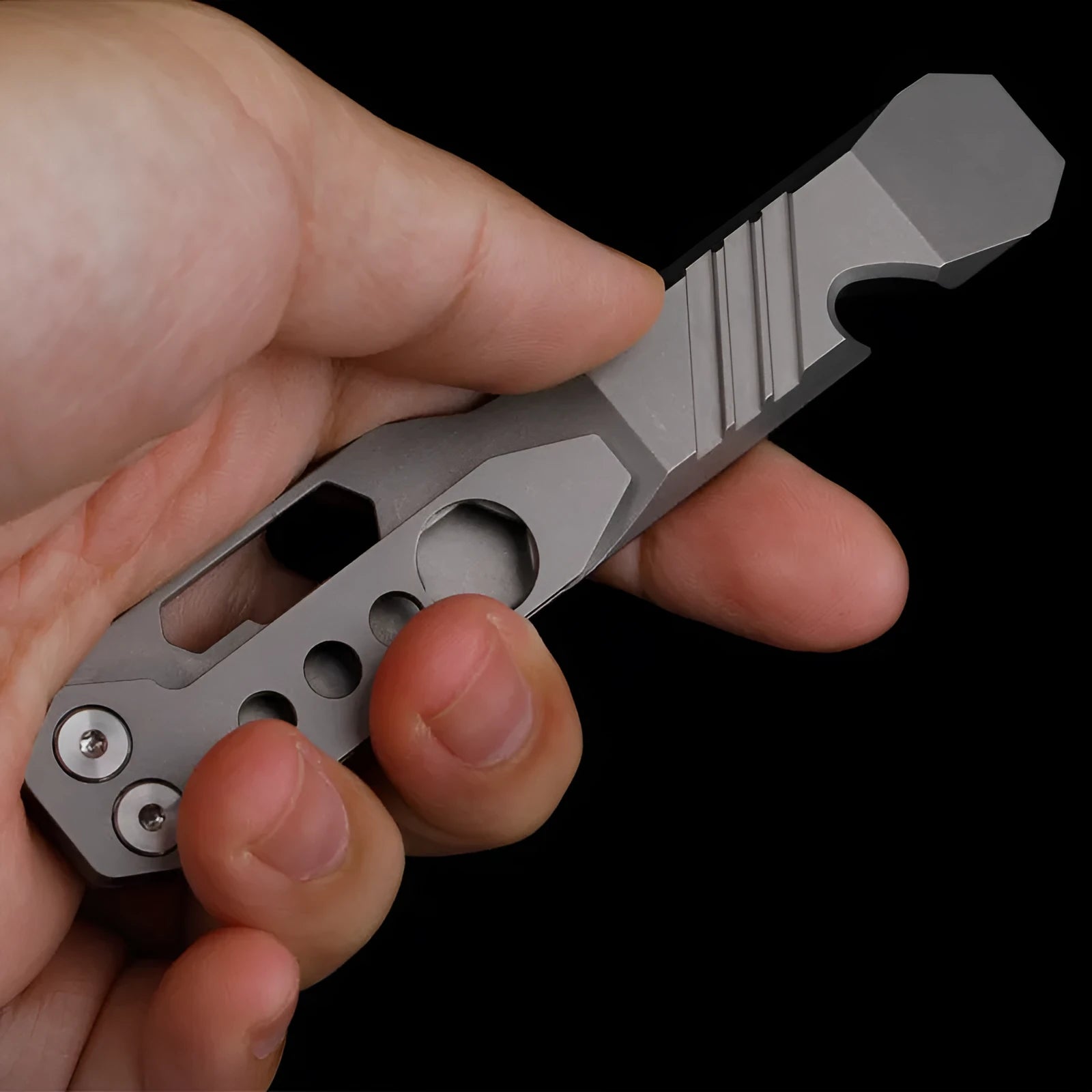 Titanium alloy multi-function crowbar tool with screwdriver tip and bottle opener in stone wash finish.