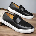 Men's black slip-on gommino loafers with tassel decoration and round toe