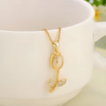 Gold-toned titanium steel necklace with a floral tulip pendant on an O-ring chain.