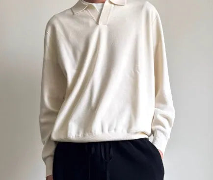 Pure wool polo sweater with a lapel collar in navy blue, shown in a loose fit on a model.