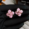Gold plated purple oil-spot glaze flower stud earrings on a copper base.