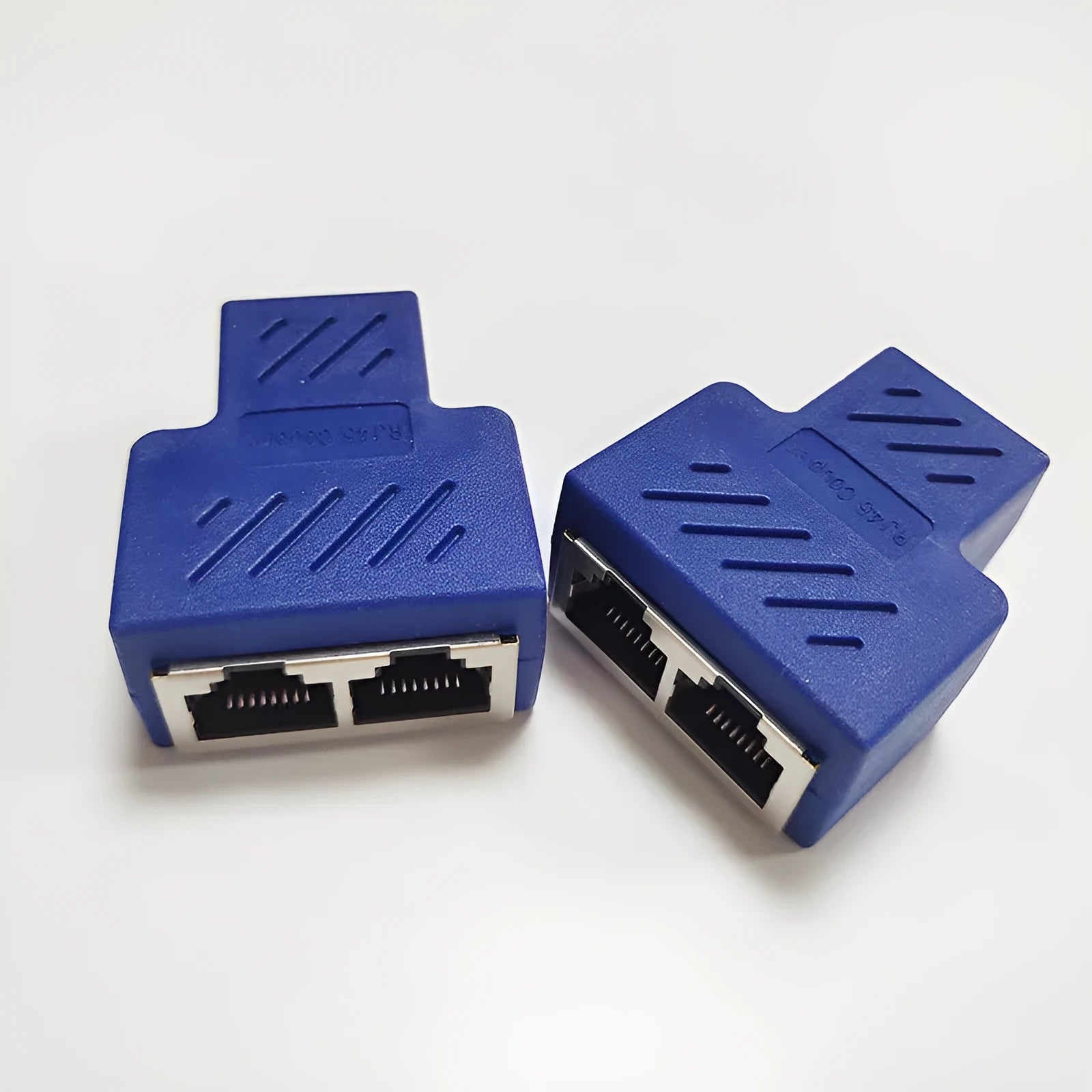 Two white RJ45 network splitter adapters for sharing one ethernet cable connection.