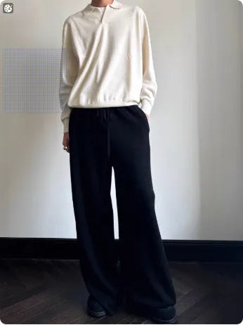 Pure wool polo sweater with a lapel collar in navy blue, shown in a loose fit on a model.
