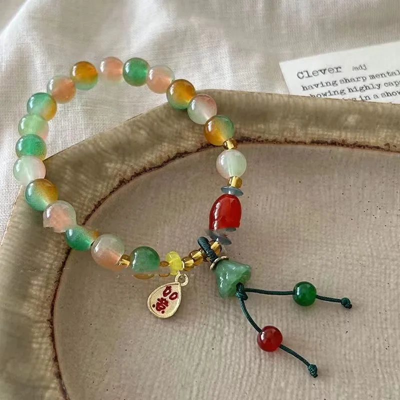 Close-up of a manually crafted lotus motif bracelet made from mixed materials in a national style.