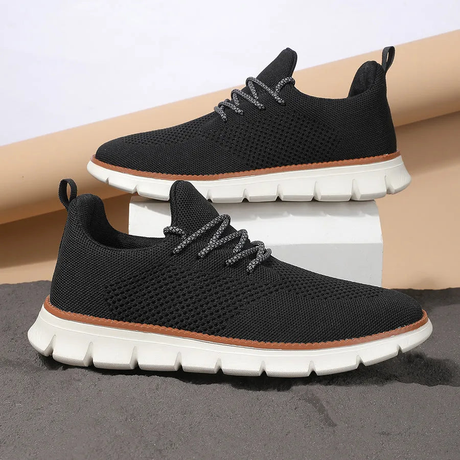 Men's grey and black low-heel casual sneakers with woven mesh fabric uppers and round toe.