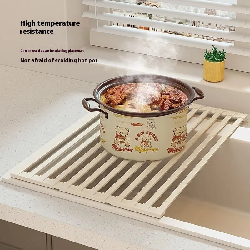 Milky white foldable stainless steel kitchen draining rack showing tri-fold mechanism