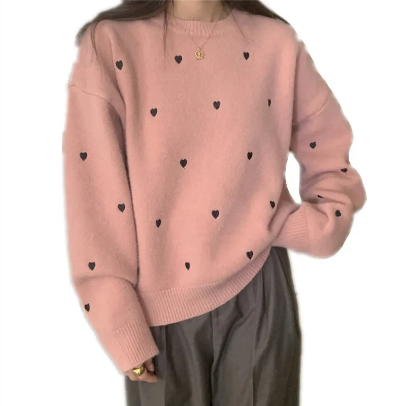 Women's loose cream embroidered acrylic pullover sweater with long sleeves, shown on a hanger.
