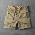 Men's stretch cotton cargo shorts in army green colour showing multiple pockets and straight-leg fit.