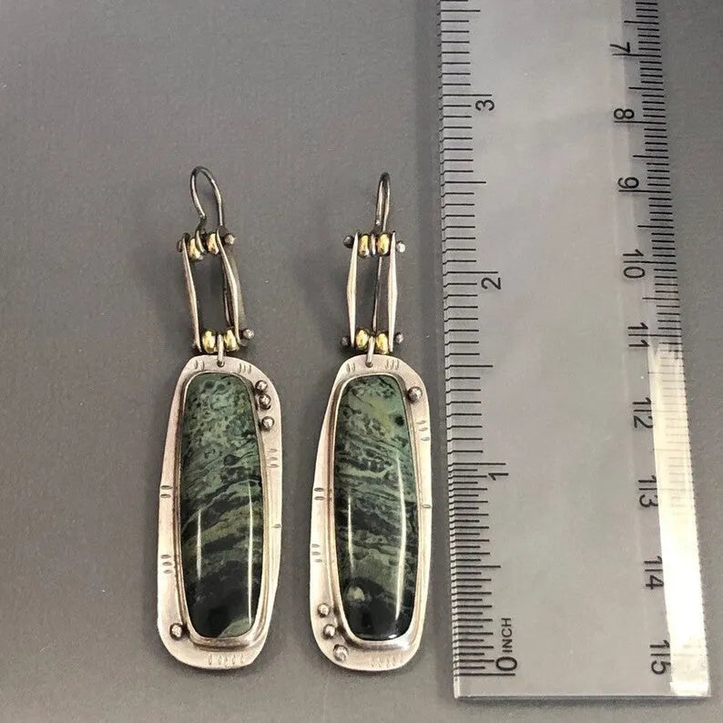A pair of simple geometric drop earrings with a grey and white marble pattern on an alloy background.