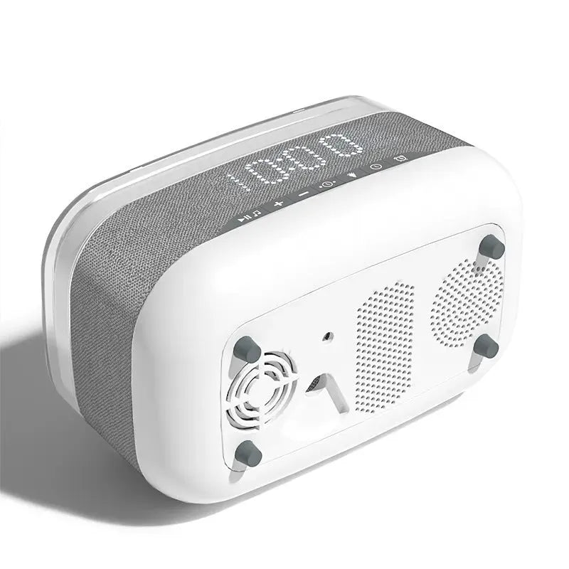 White multifunctional alarm clock with Bluetooth speaker and wireless charging pad on a bedside table.