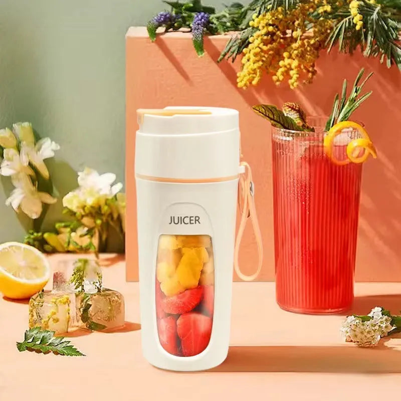 Portable USB rechargeable blender with borosilicate glass cup in fresh orange, grass green, and light purple colours.