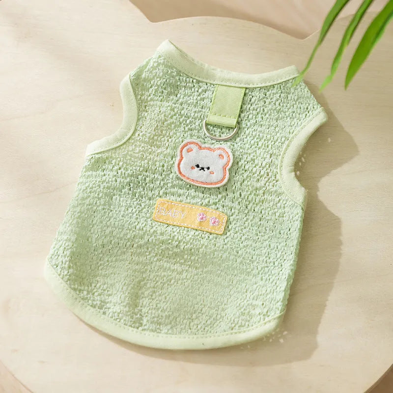 Cat wearing green bear patch cartoon clothing with hollowed-out breathable design