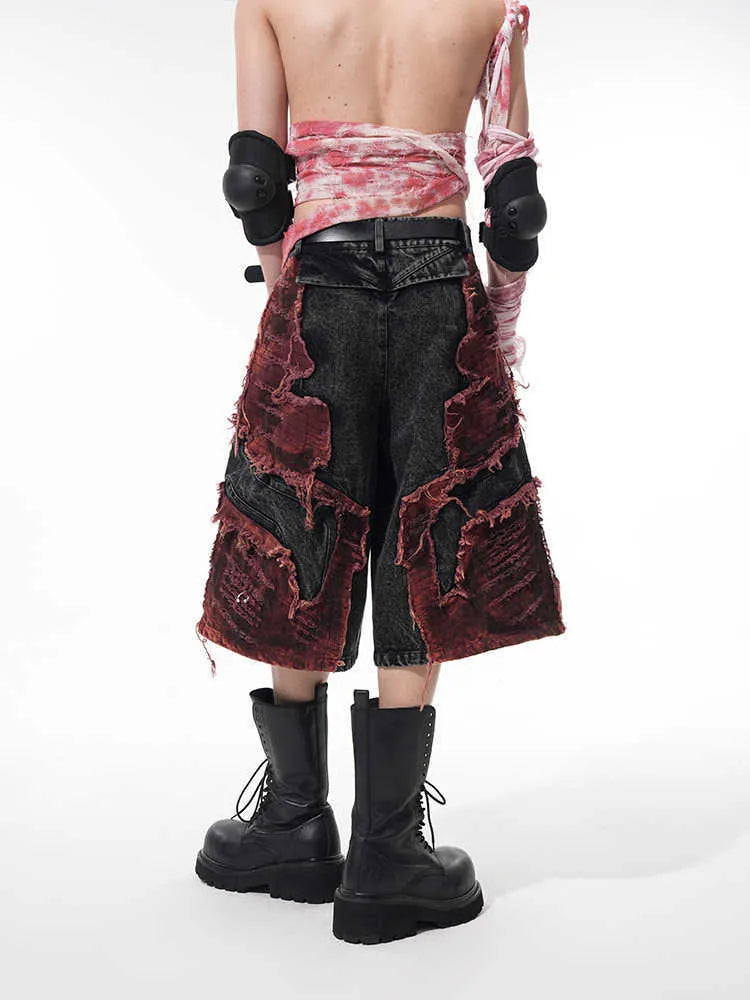Distressed denim cropped pants with wide leg silhouette and brushed stitching details