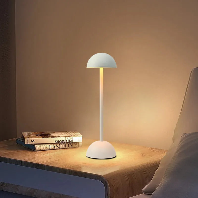 Metal mushroom table lamp in high foot design with white finish on a bar table
