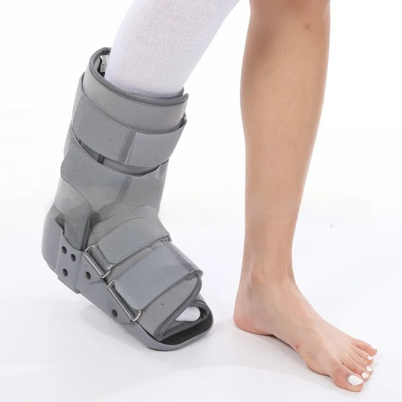 Grey and black Achilles tendon rehabilitation boot with adjustable straps and a rigid plastic shell