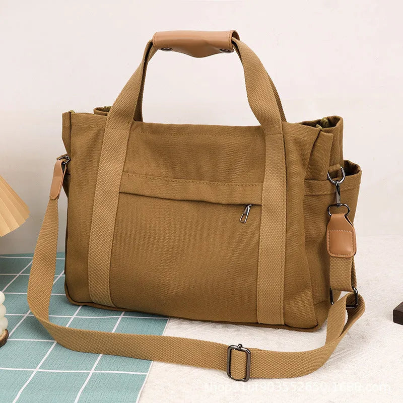Canvas tote bag with multiple internal pockets including computer pocket, shown in horizontal square shape